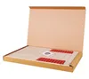 An open cardboard box containing a wooden toy house kit. Náhled obrázku produktu