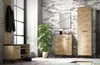 A modern entryway with a shoe cabinet, coat rack, and a tall cabinet against a brick wall. Náhled obrázku produktu