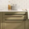 A close-up shot of modern kitchen cabinetry with black bar handles, set against a white subway tile backsplash. Produktbild-Vorschau