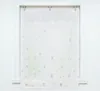 A white sheer curtain with a subtle butterfly pattern hanging in a window frame. Produktbild-Vorschau