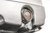 A close-up view of a metal component with a circular sight glass showing a red indicator. Produktbild-Vorschau