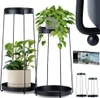 Two black metal plant stands with plants on them, and a box showing the product. Produktbild-Vorschau