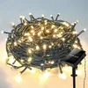 A coiled string of warm white LED lights with a solar panel on a stake. Produktbild-Vorschau