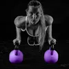 A woman is performing a kettlebell exercise in a studio setting. Podgląd zdjęcia produktu