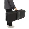 A person is holding a black saxophone case. Podgląd zdjęcia produktu