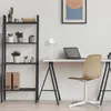 A minimalist home office setup with a desk, chair, laptop, lamp, and shelving unit. Náhled obrázku produktu