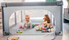 A baby is playing with toys inside a playpen. Anteprima dell’immagine prodotto