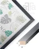 A framed picture with a botanical print and a close-up of the frame profile with dimensions. Produktbild-Vorschau