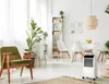 A bright, modern living room with a portable air conditioner. Voir les images du produit