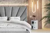 A modern bedroom setting with a bed, headboard, and bedside table. Náhled obrázku produktu