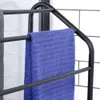 A close-up of a black metal towel rack with a blue towel and a gray towel hanging on it. The background is white subway tiles. Voir les images du produit