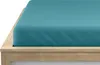 A close-up view of a turquoise fitted sheet on a wooden bed frame. Produktbild-Vorschau