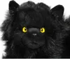 A close-up studio shot of a black plush cat toy with yellow eyes against a white background. Anteprima dell’immagine prodotto