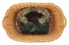 A green jacket with a fur-lined hood is placed inside a wicker basket. Produktbild-Vorschau