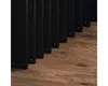 A close-up view of black lamella panels against a wooden floor. Náhled obrázku produktu