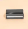 A dark gray outdoor solar wall light with a solar panel on top and a light strip below, set against a plain light peach background. Produktbild-Vorschau