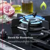 A gas stove burner with a blue flame, with food items and oil in the background, and a green flame icon in the top right corner. Produktbild-Vorschau