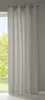 A light gray curtain hanging in front of a window with trees visible outside.