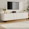 A modern living room scene featuring a white TV lowboard with a fluted front, a wall-mounted TV, and decorative items. Anteprima dell’immagine prodotto