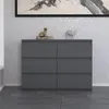 A gray dresser with six drawers is shown in a room with textured walls and a framed artwork above it. Náhľad obrázku produktu