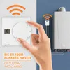 A hand is shown adjusting a wireless thermostat, with a boiler in the background, illustrating the product's functionality and range. Voir les images du produit