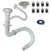 A collection of plumbing parts for a sink, including a drain assembly, flexible hose, and mounting clips, laid out on a white background. Produktbild-Vorschau
