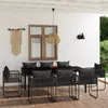 An outdoor dining set with chairs and a table on a patio, next to a wall with a window and macrame wall hanging. Produktbild-Vorschau