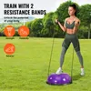 A woman is exercising outdoors on a balance ball with resistance bands. Produktbild-Vorschau