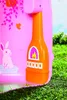A close-up of a pink toy cottage with an orange stove and a white rabbit decoration, set against a grassy background. Produktbild-Vorschau