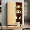 A modern wooden display cabinet with two doors and open shelving, filled with decorative items and books, in a well-lit room. Produktbild-Vorschau