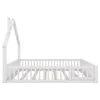 A white wooden house-shaped bed frame with a slatted base and a partial railing on the side, shown from the side view against a white background. Náhľad obrázku produktu