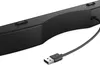 A close-up view of a black soundbar with a USB cable attached. Produktbild-Vorschau