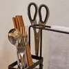 A close-up view of kitchen utensils and a towel holder. Voir les images du produit
