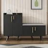 A black shoe cabinet with a gray upholstered bench seat, set against a light-colored paneled wall. Podgląd zdjęcia produktu