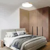 A bedroom with a bed, wardrobe, and ceiling light. Voir les images du produit