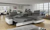 A modern living room with a sectional sofa, kitchen area, and large windows overlooking a city. Produktbild-Vorschau
