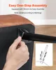 A hand is shown attaching a metal leg to the underside of a brown upholstered ottoman using an Allen wrench. An inset diagram illustrates the assembly process with screws and a leg. Náhľad obrázku produktu