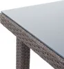 A close-up view of the corner of a poly-rattan garden table with a glass top. Podgląd zdjęcia produktu