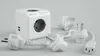 A white PowerCube DuoUSB travel adapter with multiple plugs and USB ports is displayed on a light gray background. Produktbild-Vorschau