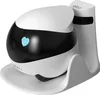 A white robot with a black face and a blue heart on its face is sitting on a white charging dock. Náhled obrázku produktu