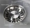 Close-up of a stainless steel sink drain with descriptive text labels. Produktbild-Vorschau