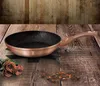 A rose gold frying pan with a granite coating is displayed on a wooden table, with roses and chocolate pieces as decoration. Náhled obrázku produktu