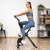 A woman is exercising on a stationary bike in a home gym setting. Náhľad obrázku produktu