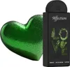 A green heart-shaped object and a black perfume bottle are displayed against a white background. Voir les images du produit