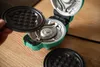 A hand is holding a waffle maker plate above the open waffle maker. Náhled obrázku produktu
