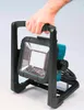 A hand holding a portable LED work light. Podgląd zdjęcia produktu