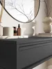 A close-up view of a black console table with a drawer, showing decorative items on top. Anteprima dell’immagine prodotto