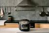 A modern kitchen counter with a rice cooker and kitchen utensils. Produktbild-Vorschau