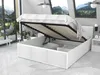 A white storage bed with its lift-up frame open, revealing the slatted base and pillows inside. The bed is in a modern room with large windows showing a mountain landscape. Produktbild-Vorschau
