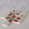A white ceramic serving and cutting board with a strawberry pattern. Produktbild-Vorschau